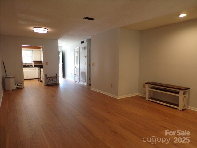 833 21st Ave NE Unit 833, Hickory, NC 28601 - unfurnished living room with light wood-style flooring and recessed lighting