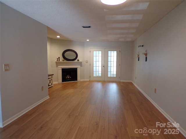 833 21st Ave NE Unit 833, Hickory, NC 28601 - unfurnished living room with wood finished floors, a fireplace, recessed lighting, and french doors