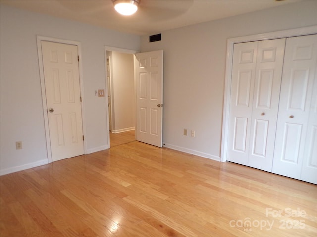 833 21st Ave NE Unit 833, Hickory, NC 28601 - unfurnished bedroom with light wood-style floors, a closet, and a ceiling fan