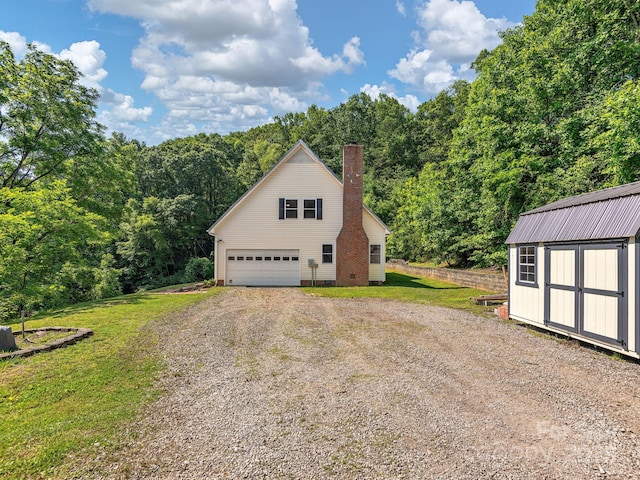345 Bob Barnwell Rd, Fletcher, NC 28732 - view of home's exterior featuring a wooded view, a chimney, gravel driveway, a shed, and a lawn