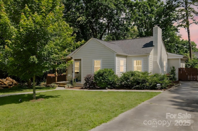 3307 Draper Ave, Charlotte, NC 28205 - view of front of home with a front yard, a chimney, and a shingled roof