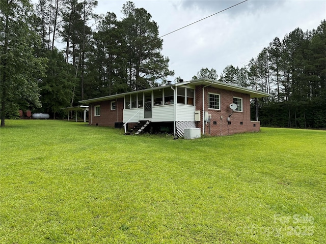 2350 Grubb Ferry Rd, Salisbury, NC 28144 - back of house with a yard, brick siding, a sunroom, and crawl space