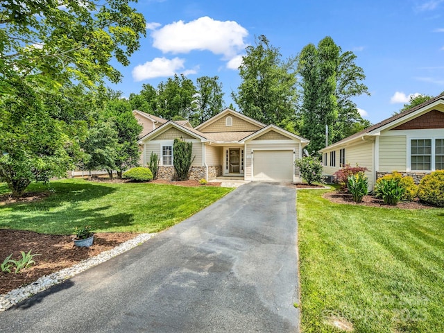 114 Fairway View Dr, Etowah, NC 28729 - view of front facade with stone siding, an attached garage, asphalt driveway, and a front yard