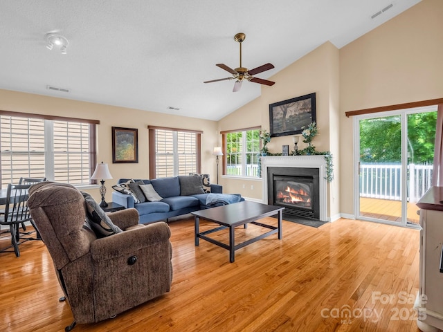 114 Fairway View Dr, Etowah, NC 28729 - living room with light wood-type flooring, ceiling fan, a fireplace with flush hearth, plenty of natural light, and high vaulted ceiling
