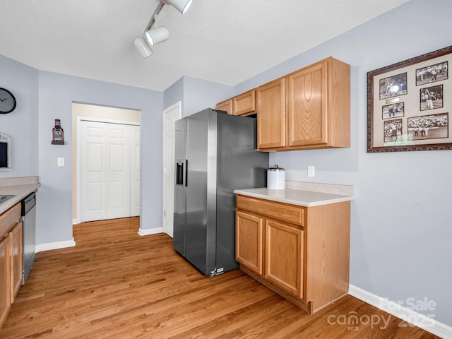 114 Fairway View Dr, Etowah, NC 28729 - kitchen with appliances with stainless steel finishes, light wood-type flooring, light countertops, track lighting, and a textured ceiling