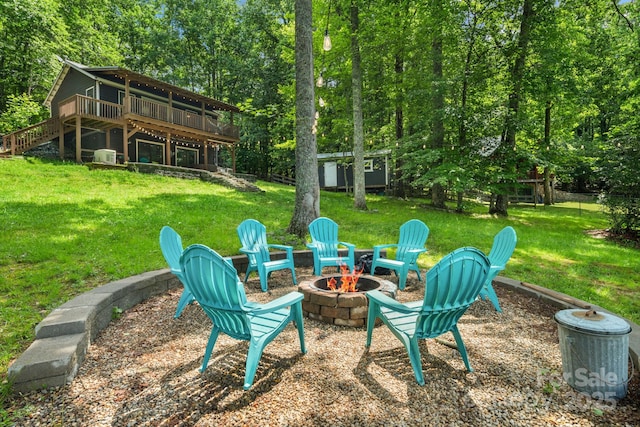 37 Poplar Dr, Rosman, NC 28772 - view of grassy yard featuring a fire pit, a deck, stairs, and an outbuilding
