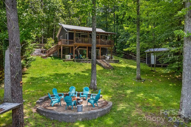 37 Poplar Dr, Rosman, NC 28772 - back of property with stairway, an outdoor fire pit, a wooden deck, a shed, and a lawn