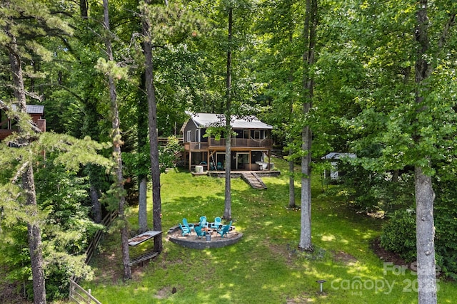 37 Poplar Dr, Rosman, NC 28772 - view of green lawn with a deck, a fire pit, stairway, and a view of trees