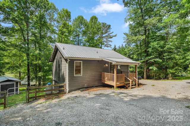 37 Poplar Dr, Rosman, NC 28772 - view of front facade with a metal roof, driveway, and a gate