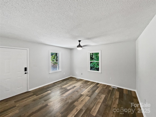 232 Branchwood Cir, Kings Mountain, NC 28086 - empty room featuring healthy amount of natural light, dark wood-type flooring, a textured ceiling, and a ceiling fan
