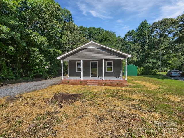 232 Branchwood Cir, Kings Mountain, NC 28086 - bungalow with covered porch, a storage unit, and a front yard