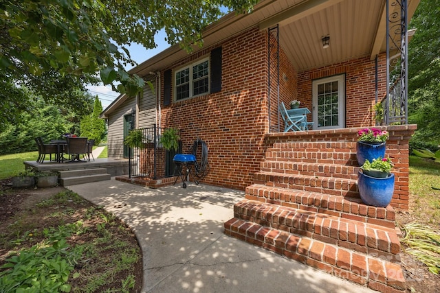 2 Enka Orchard St Unit 21A, Candler, NC 28715 - view of exterior entry with brick siding and a patio area