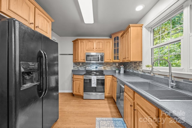 2 Enka Orchard St Unit 21A, Candler, NC 28715 - kitchen featuring stainless steel appliances, light wood-type flooring, dark countertops, glass insert cabinets, and tasteful backsplash