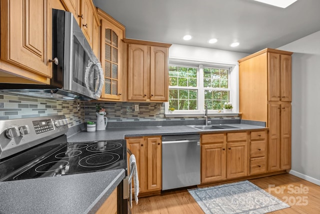 2 Enka Orchard St Unit 21A, Candler, NC 28715 - kitchen with stainless steel appliances, tasteful backsplash, glass insert cabinets, light wood finished floors, and dark countertops