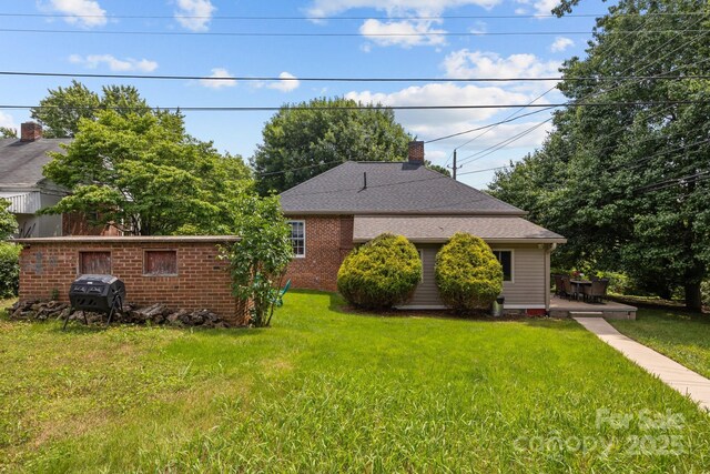 2 Enka Orchard St Unit 21A, Candler, NC 28715 - view of front of house featuring a front yard, a chimney, and brick siding