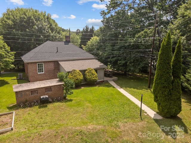 2 Enka Orchard St Unit 21A, Candler, NC 28715 - view of front of property with brick siding, a front lawn, a chimney, and a shingled roof
