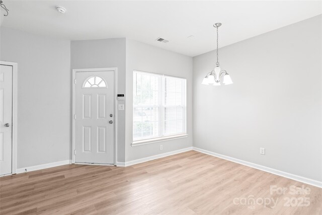 12452 Stratfield Place Cir, Pineville, NC 28134 - foyer entrance featuring a chandelier and light wood-style flooring