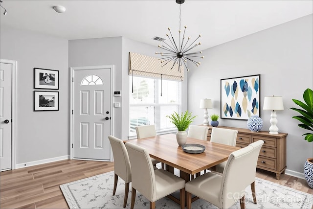12452 Stratfield Place Cir, Pineville, NC 28134 - dining room featuring a chandelier and light wood-type flooring