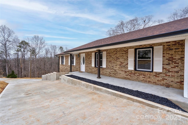 238 Lincoln Dr, Forest City, NC 28043 - view of property exterior featuring brick siding, a porch, and roof with shingles