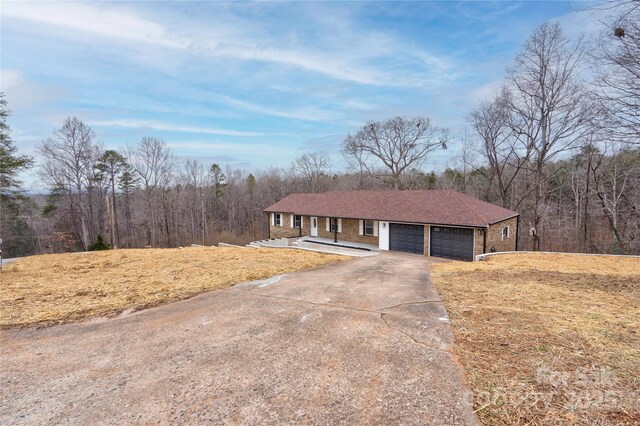 238 Lincoln Dr, Forest City, NC 28043 - ranch-style home featuring driveway, an attached garage, and a forest view
