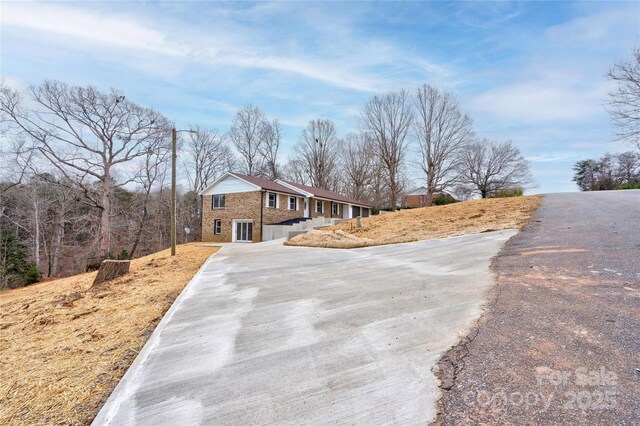 238 Lincoln Dr, Forest City, NC 28043 - view of front of house featuring concrete driveway and brick siding