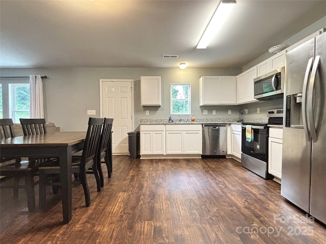 1916 Country Way, Hickory, NC 28601 - kitchen featuring stainless steel appliances, white cabinetry, dark wood-type flooring, and light countertops
