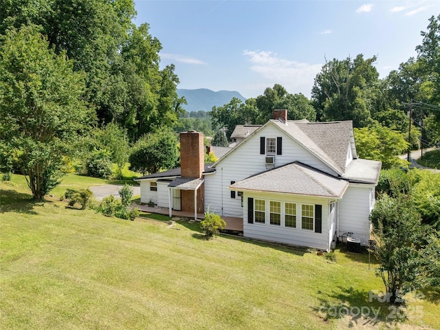 34 Lockhart Rd, Tryon, NC 28782 - rear view of property with a chimney, a shingled roof, a lawn, and a deck with mountain view