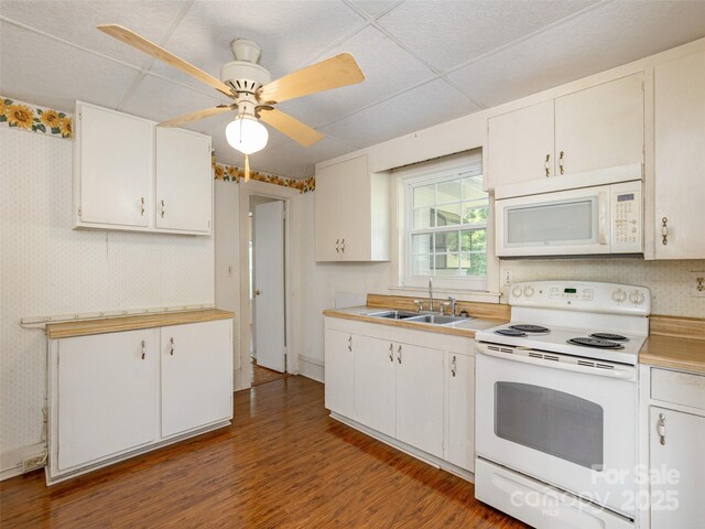 34 Lockhart Rd, Tryon, NC 28782 - kitchen featuring white appliances, wood finished floors, light countertops, white cabinets, and wallpapered walls