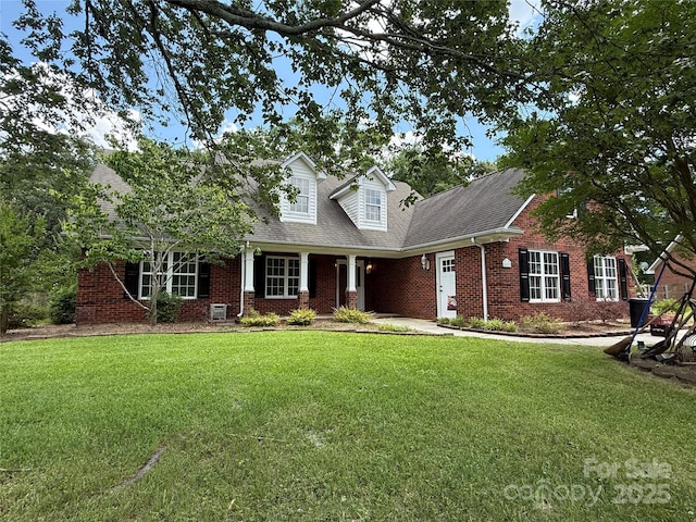 4402 Poxon Ln, Monroe, NC 28110 - cape cod-style house featuring brick siding, a front yard, and a shingled roof