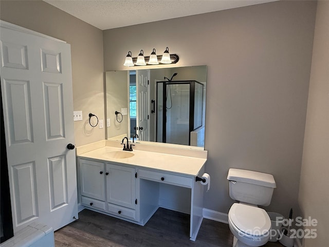 4402 Poxon Ln, Monroe, NC 28110 - bathroom featuring wood finished floors, vanity, a stall shower, and a textured ceiling