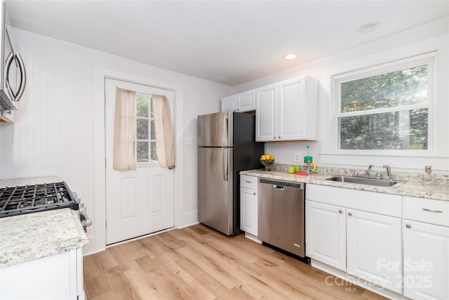 13414 Central Ave, Huntersville, NC 28078 - kitchen with stainless steel appliances, white cabinets, light wood-type flooring, ornamental molding, and light stone counters