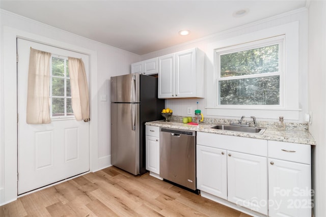 13414 Central Ave, Huntersville, NC 28078 - kitchen with stainless steel appliances, crown molding, light wood-style flooring, white cabinets, and light stone countertops