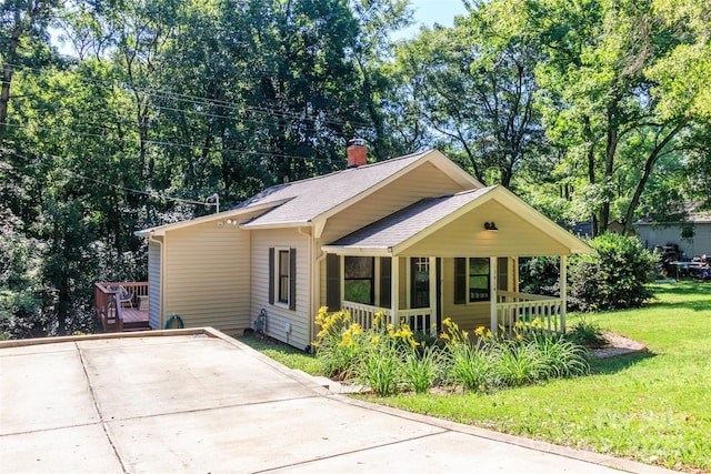 13414 Central Ave, Huntersville, NC 28078 - bungalow featuring a porch, a shingled roof, a front lawn, a chimney, and concrete driveway