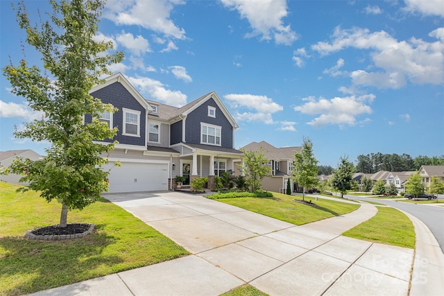 205 Falls Cove Dr, Troutman, NC 28166 - craftsman house with concrete driveway, a front yard, an attached garage, and a residential view