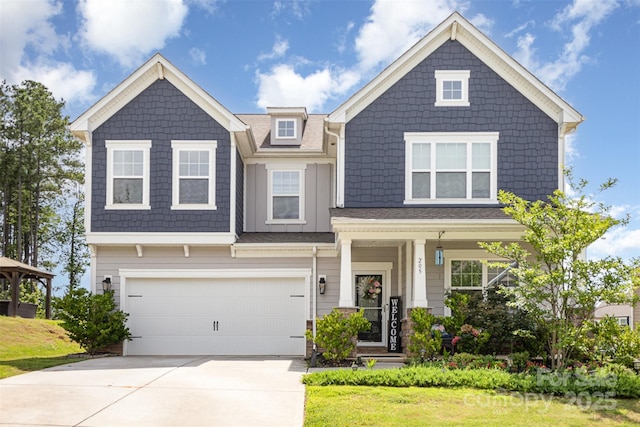 205 Falls Cove Dr, Troutman, NC 28166 - craftsman house featuring driveway, an attached garage, and covered porch