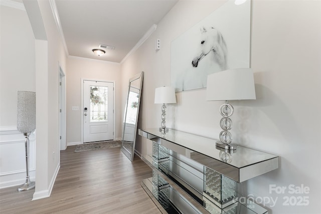 205 Falls Cove Dr, Troutman, NC 28166 - entrance foyer with ornamental molding, wood finished floors, and arched walkways