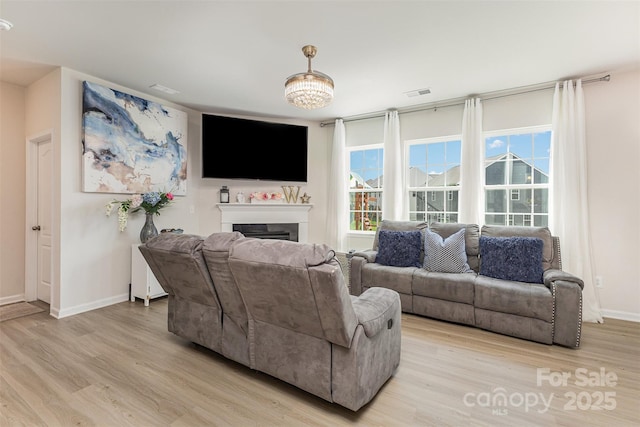 205 Falls Cove Dr, Troutman, NC 28166 - living room featuring light wood-style floors and a fireplace