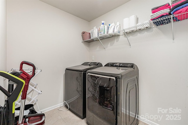 205 Falls Cove Dr, Troutman, NC 28166 - washroom featuring washing machine and dryer and light tile patterned floors