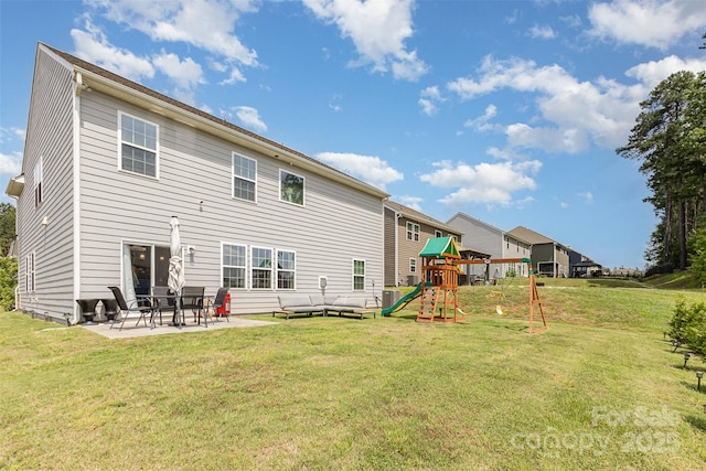 205 Falls Cove Dr, Troutman, NC 28166 - back of property with a playground, a patio area, and a lawn