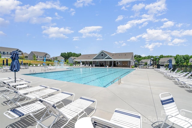 205 Falls Cove Dr, Troutman, NC 28166 - community pool featuring a patio area and a residential view