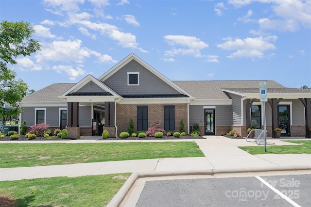 205 Falls Cove Dr, Troutman, NC 28166 - view of front of home with brick siding, a front yard, and french doors