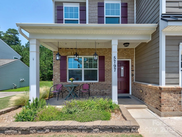 5797 Mcclintock Dr, Denver, NC 28037 - doorway to property featuring brick siding and a porch
