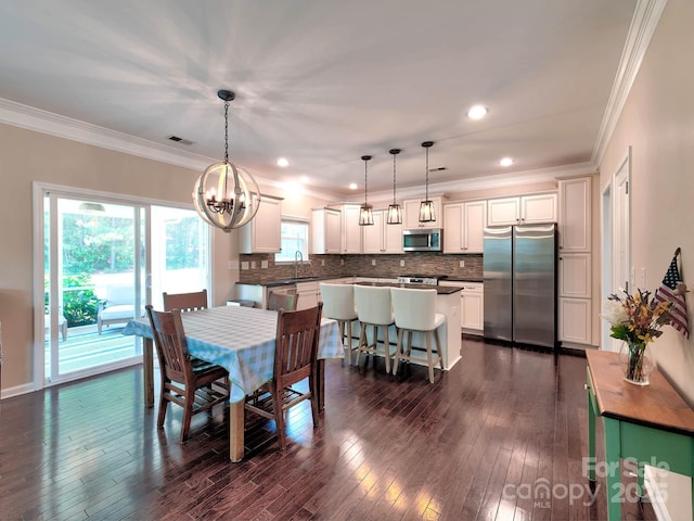 5797 Mcclintock Dr, Denver, NC 28037 - dining room featuring a chandelier, ornamental molding, dark wood-style floors, and recessed lighting