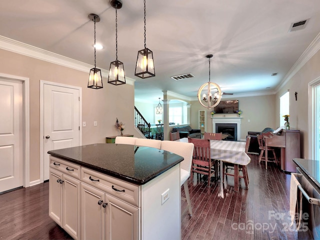 5797 Mcclintock Dr, Denver, NC 28037 - kitchen with a chandelier, dark wood-style flooring, ornamental molding, hanging light fixtures, and a fireplace