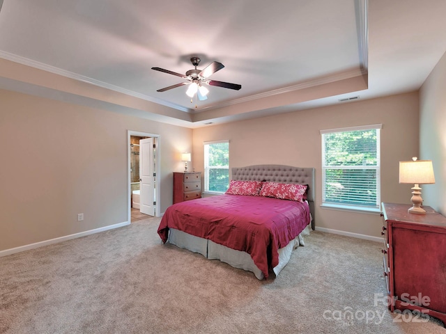 5797 Mcclintock Dr, Denver, NC 28037 - carpeted bedroom featuring a raised ceiling, ornamental molding, multiple windows, ensuite bath, and a ceiling fan