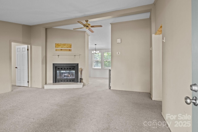 200 Southwood Park Rd, Mooresville, NC 28117 - unfurnished living room with carpet floors, a glass covered fireplace, a ceiling fan, a chandelier, and beamed ceiling