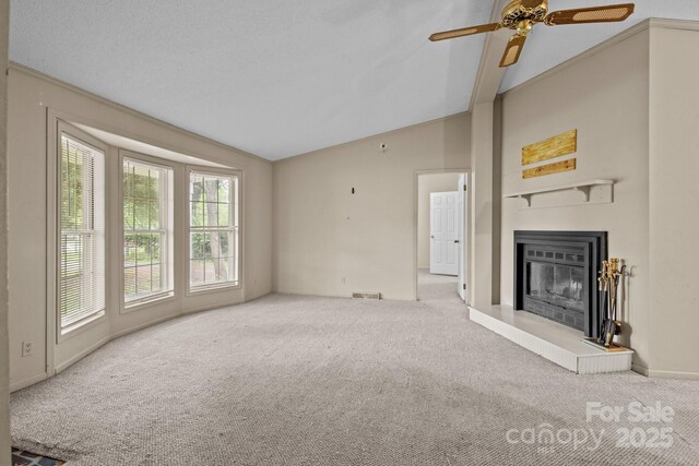 200 Southwood Park Rd, Mooresville, NC 28117 - unfurnished living room featuring carpet floors, lofted ceiling, a glass covered fireplace, and a ceiling fan