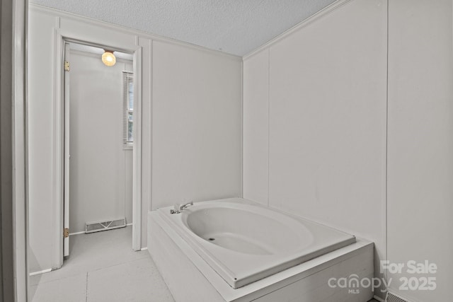 200 Southwood Park Rd, Mooresville, NC 28117 - full bathroom featuring a garden tub, a textured ceiling, and tile patterned flooring