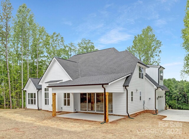 4032 Brandy Creek Ct, Clover, SC 29710 - back of house with concrete driveway, a patio area, a shingled roof, and a garage