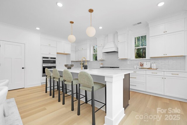 4032 Brandy Creek Ct, Clover, SC 29710 - kitchen with premium range hood, light countertops, tasteful backsplash, recessed lighting, and light wood-type flooring